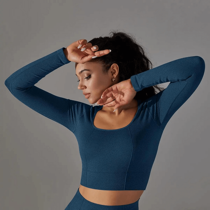 Woman wearing Seamless Bodycon Crop Top with Long Sleeves, perfect for yoga and cycling, showcasing breathable nylon-spandex blend.